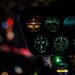Illuminated dashboard dials of a helicopter flying at night