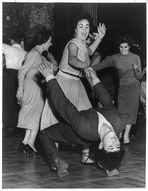 Black-and-white photo of energetic couples dancing on a social floor